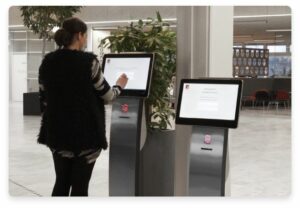 Picture of FrontDesk kiosks and woman